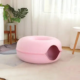 TAILTRAIL Cat Donut Bed in pink fabric, soft and cozy design for pets, perfect for relaxation and play.