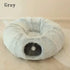 Soft grey TAILTRAIL 2-in-1 round tunnel cat bed with plush interior and playful design.