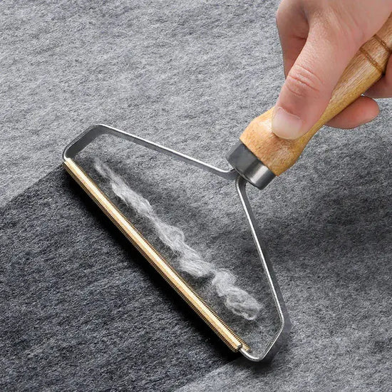 Eco-friendly pet hair remover brush by TAILTRAIL effectively collects pet hair from fabrics.