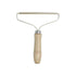 TAILTRAIL pet hair remover brush with wooden handle for easy hair removal from furniture and clothing.