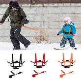 Person and child using TAILTRAIL Safety Rope Ski Dog Training Belt in snow with accessories in black, red, and orange.